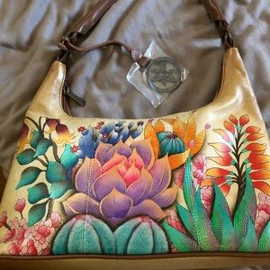 Anuschka brand new never used! Bag comes with dust bag & key chain on zipper!